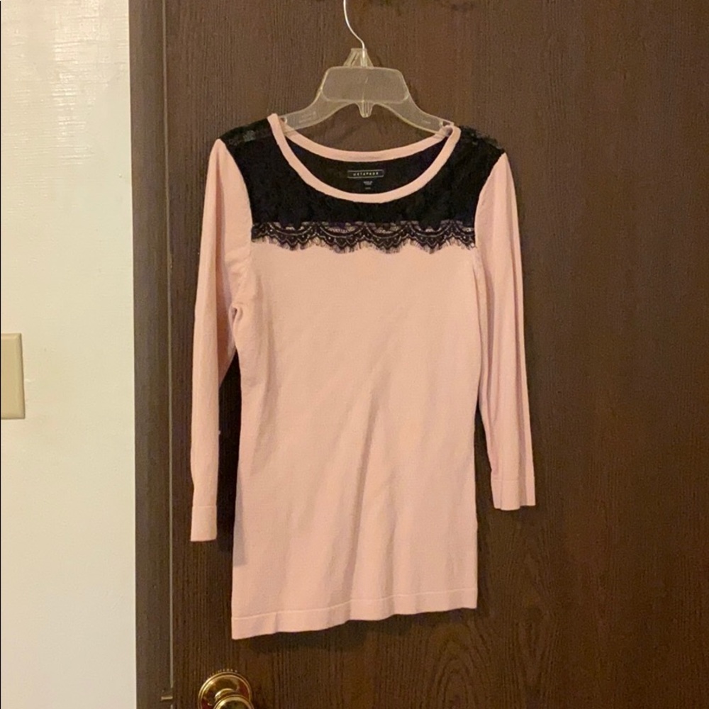 Pink sweater with black lace neckline